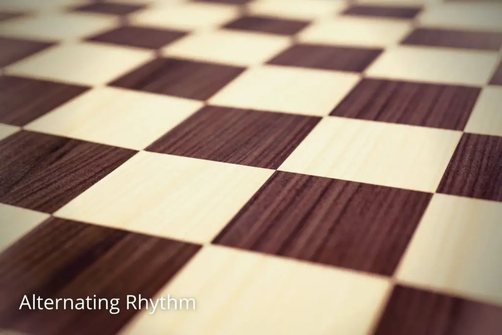 Closeup image of chess board with alternative colors depicting alternating rhythm in art