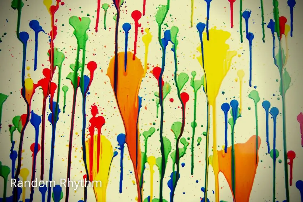 Random splash of color on wall and colors dripping depicting random rhythm in art