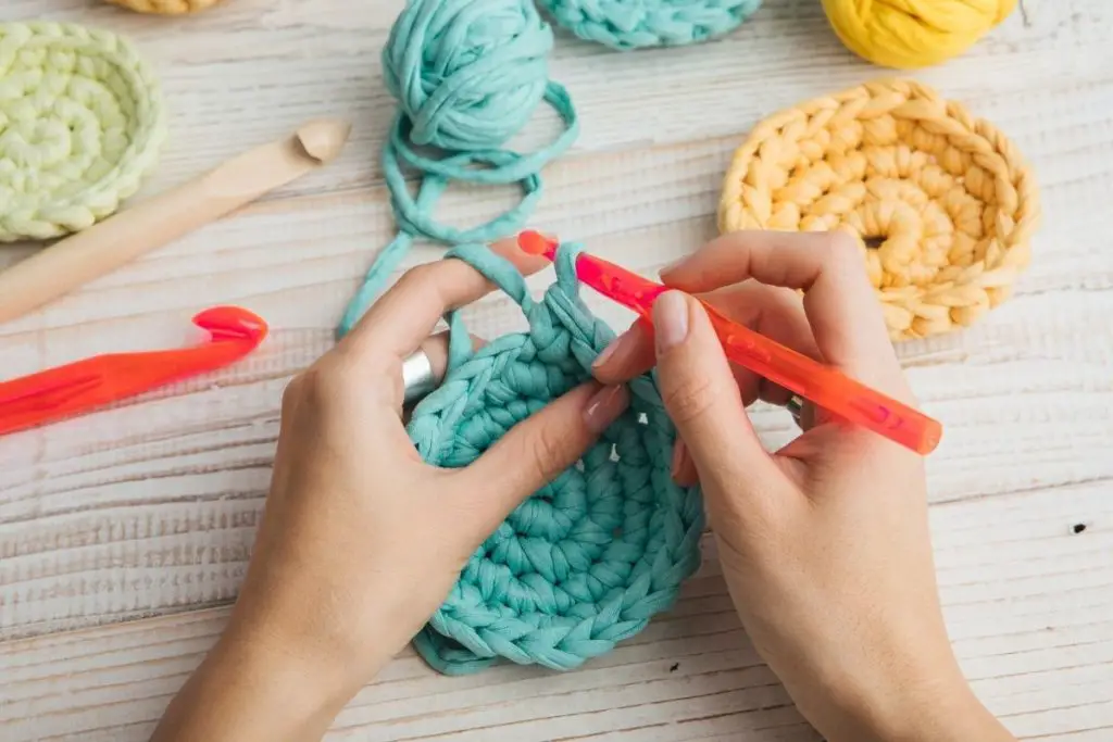 two lady hands doing crochet craft work