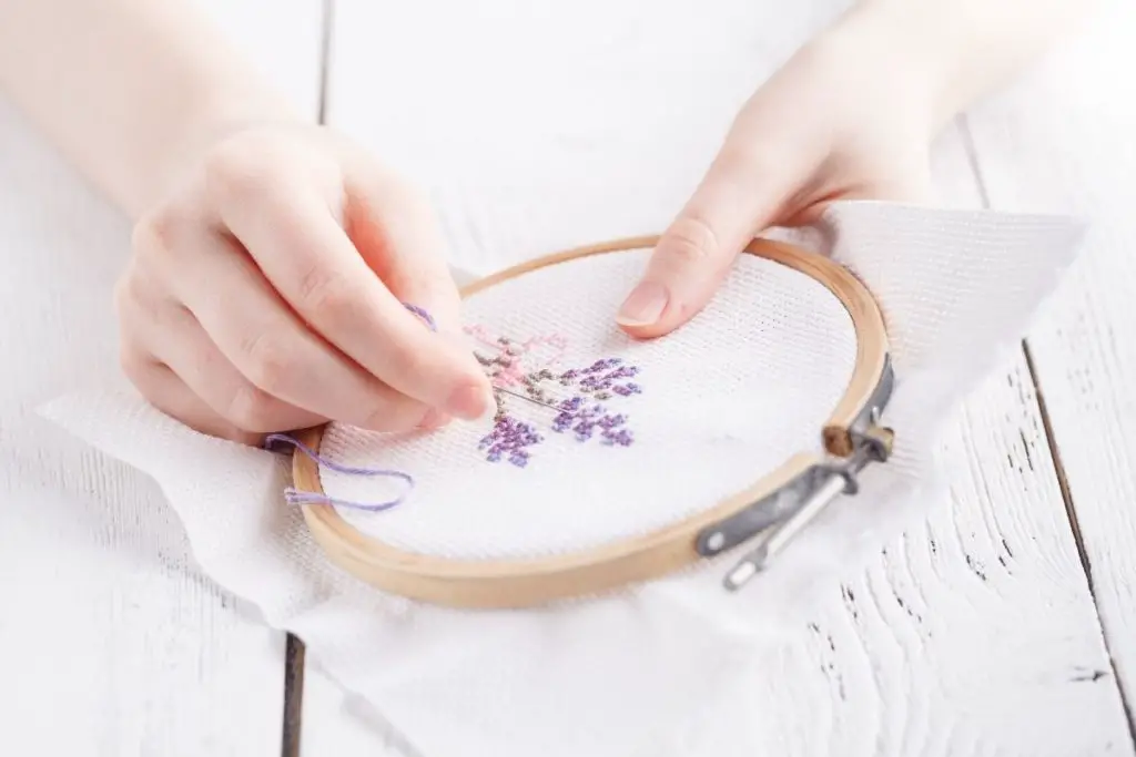 two hands doing embroidery craft work