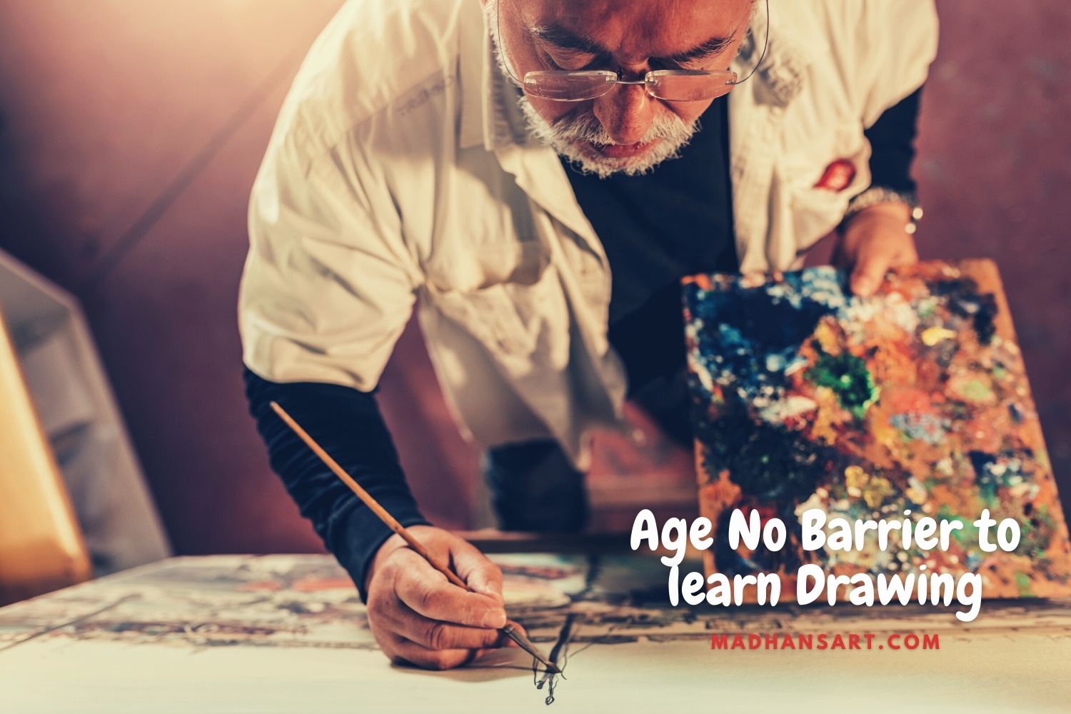 old man standing and doing oil painting depicting age is not a barrier