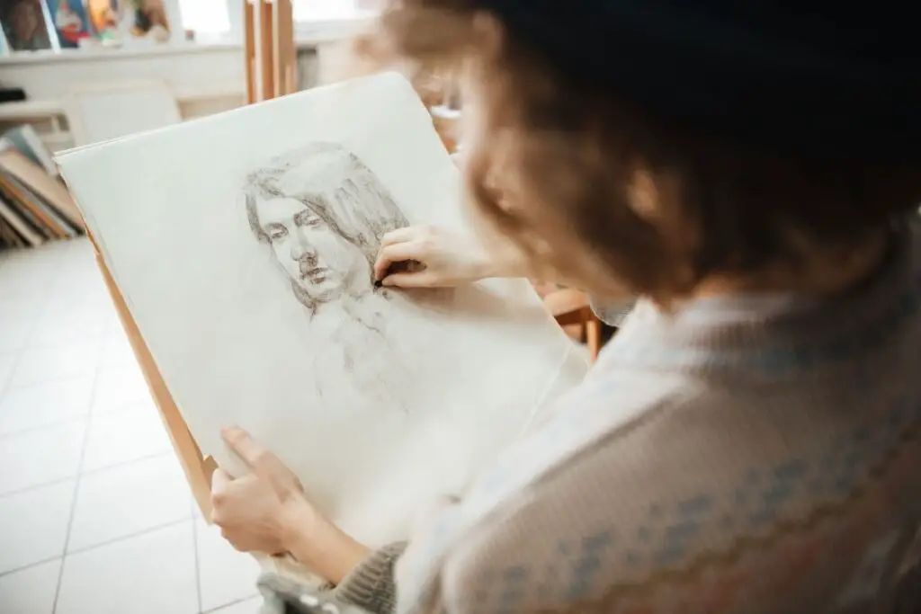 Artist drawing a Portrait with Charcoal on Paper