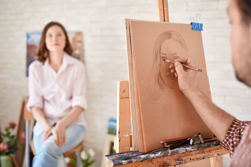 Artist drawing a pencil portrait of a lady sitting in front