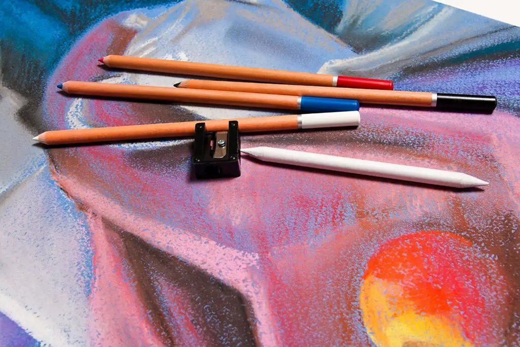 Pastel Pencils lying on a beautiful Pastel Drawing