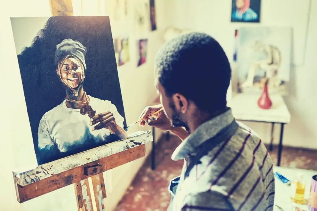 A visual artist creating an oil painting on canvas on an easel