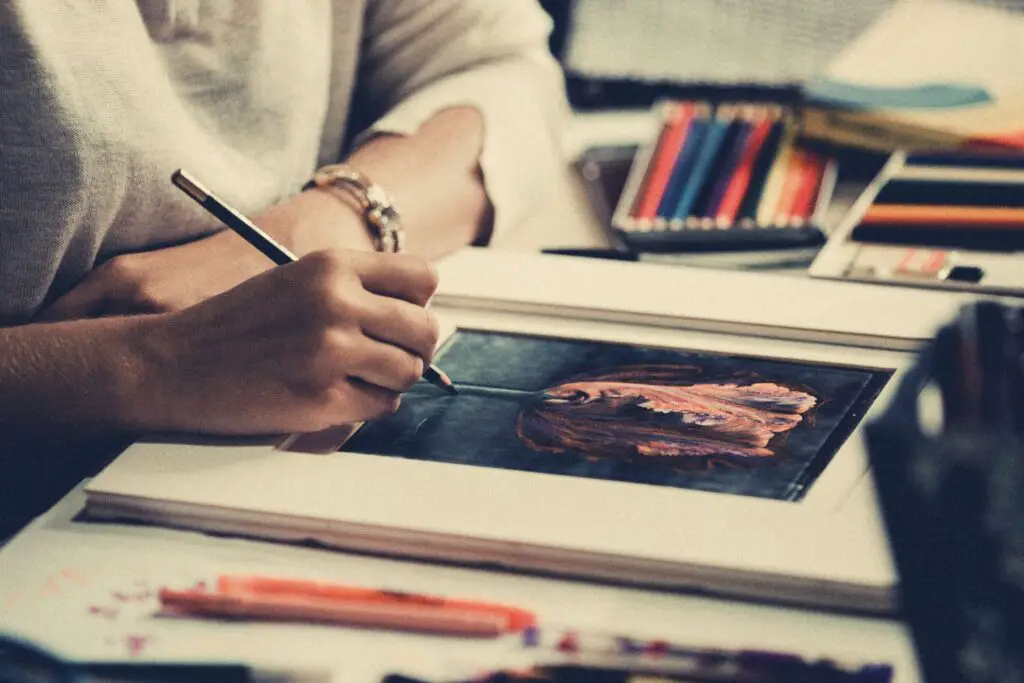 closeup photo of an artists painting a picture