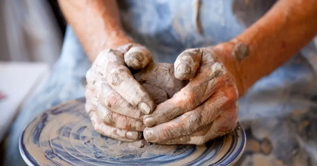 A hand of a potter, crating a pot