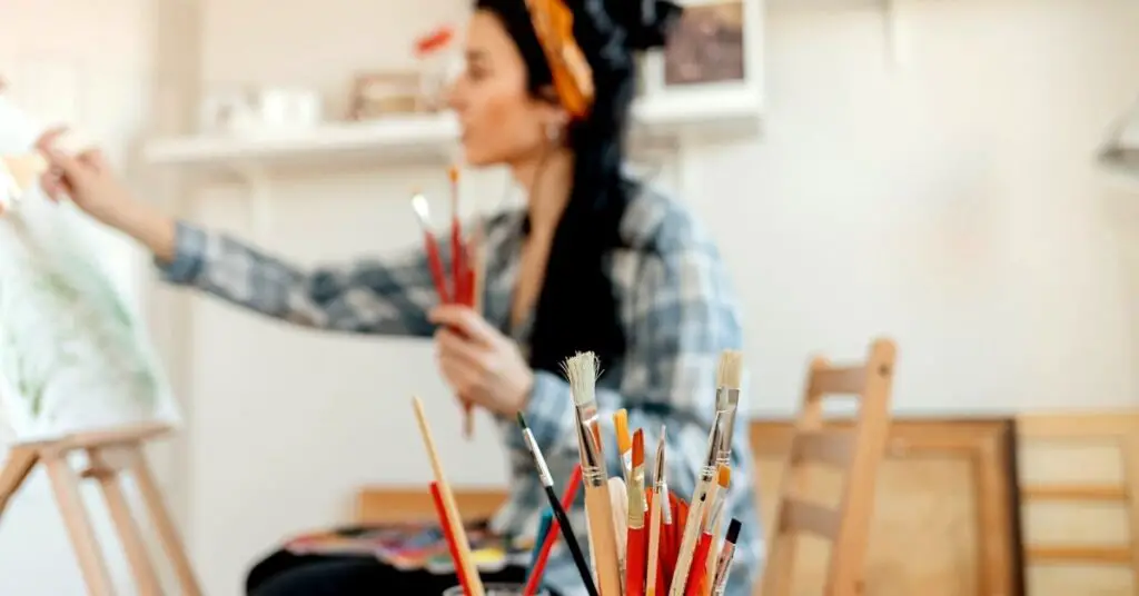 Image of an artist painting on an easel